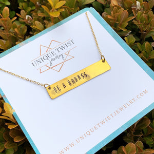 Hand-Stamped "Be a Badass" brass bar necklace. Handmade fashion accessories by Unique Twist Jewelry.