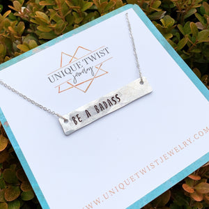 Hand-Stamped "Be a Badass" aluminum bar necklace. Handmade fashion accessories by Unique Twist Jewelry.