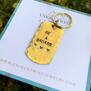 Hand stamped "Be a Badass" Brass dog tag style keychain. Handmade fashion accessories by Unique Twist Jewelry.