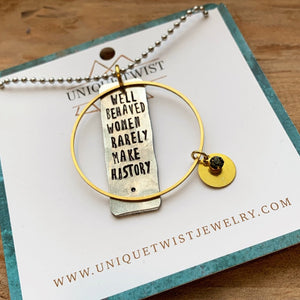 Hand stamped "Well Behaved Women Rarely Make History" piece with brass charms and a lucite gem on a 30" ball chain. Handmade by Unique Twist Jewelry