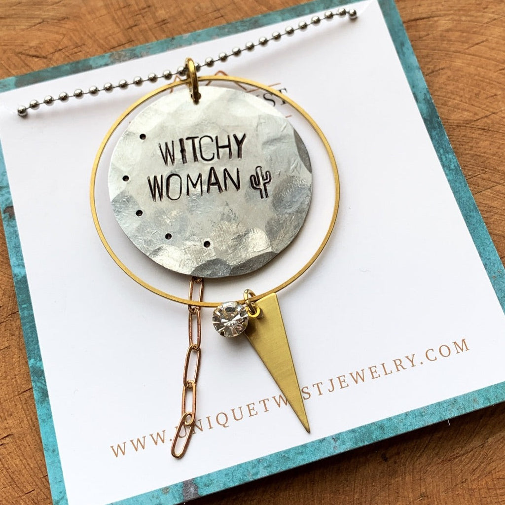 Handstamped "Witchy Woman" aluminum pendant with brass charms and a lucite gem on a 30" ball chain. Handmade by Unique Twist Jewelry