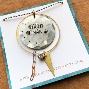 Handstamped "Witchy Woman" aluminum pendant with brass charms and a lucite gem on a 30" ball chain. Handmade by Unique Twist Jewelry