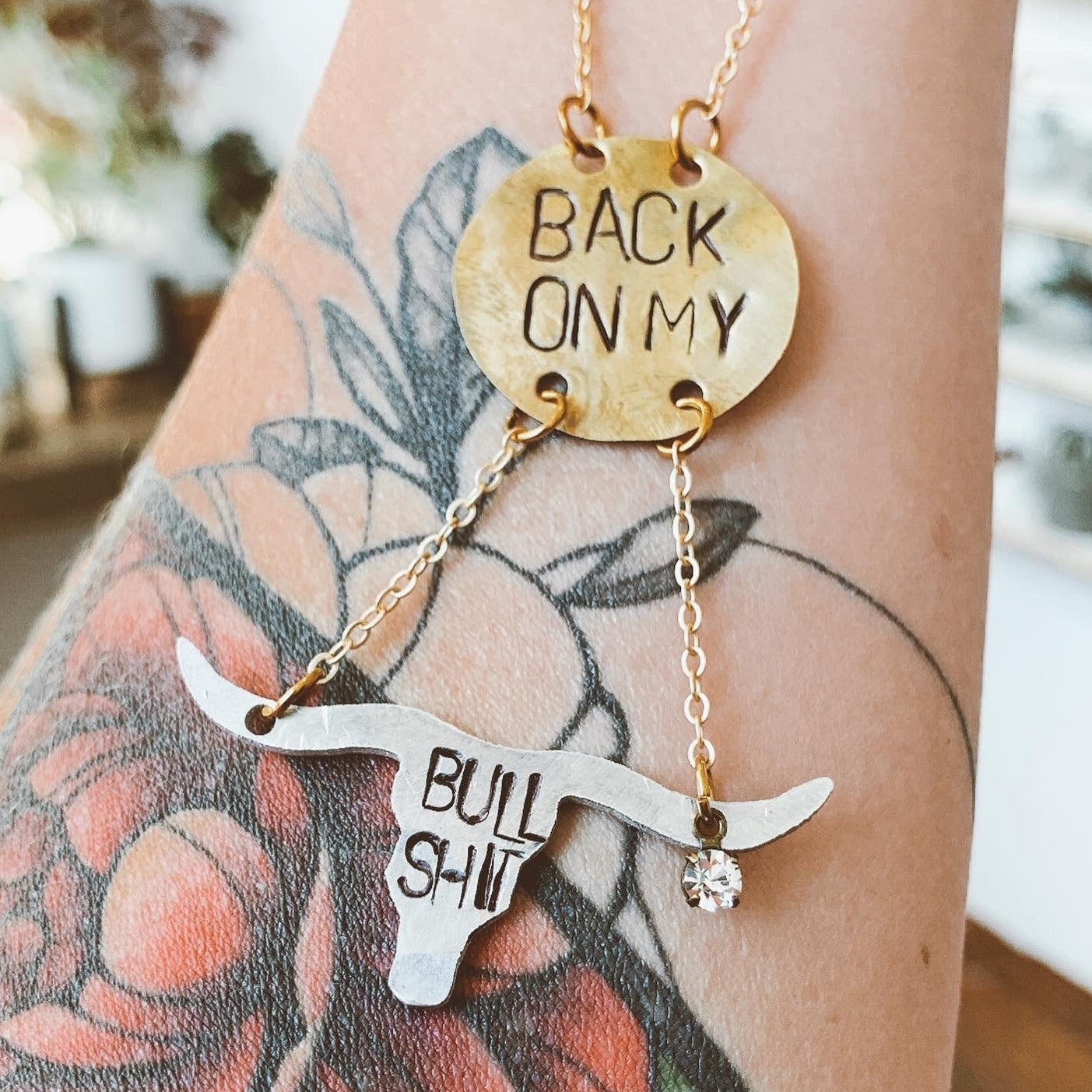 "Back on my Bullshit" necklace. Hand-stamped aluminum and brass with a texas long horn cattle silhouette. Handmade fashion accessories by Unique Twist Jewelry.