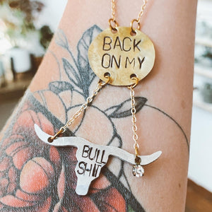 "Back on my Bullshit" necklace. Hand-stamped aluminum and brass with a texas long horn cattle silhouette. Handmade fashion accessories by Unique Twist Jewelry.
