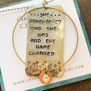 Handstamped "She Remembered who she was and the Game Changed" Necklace. Aluminum with brass charms and a lucite gem on a 30" ball chain. Handmade by Uniwue Twist Jewelry